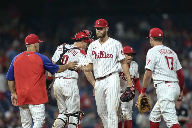 Phillies pitcher Zack Wheeler hands the ball over to manager Joe Girardi after Wheeler served up a 3 run home run to Rays Francisco Mejia during the 9th inning at Citizens Bank Park in Philadelphia, Wednesday, August 25, 2021