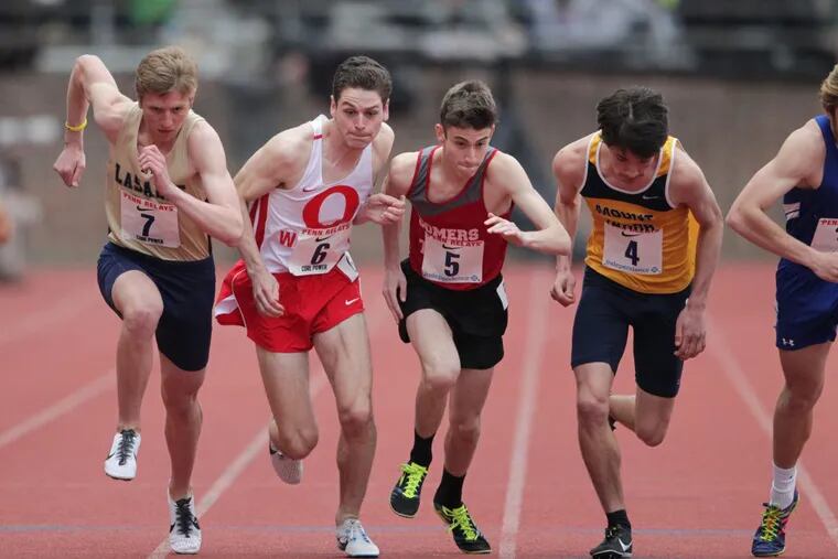 Evan Addison, left,.of La Salle College and Liam Conway, 2nd from left, at the start of the High School Boys' Mile Run Championship at the Penn Relays on April 27, 2018. CHARLES FOX / Staff Photographer