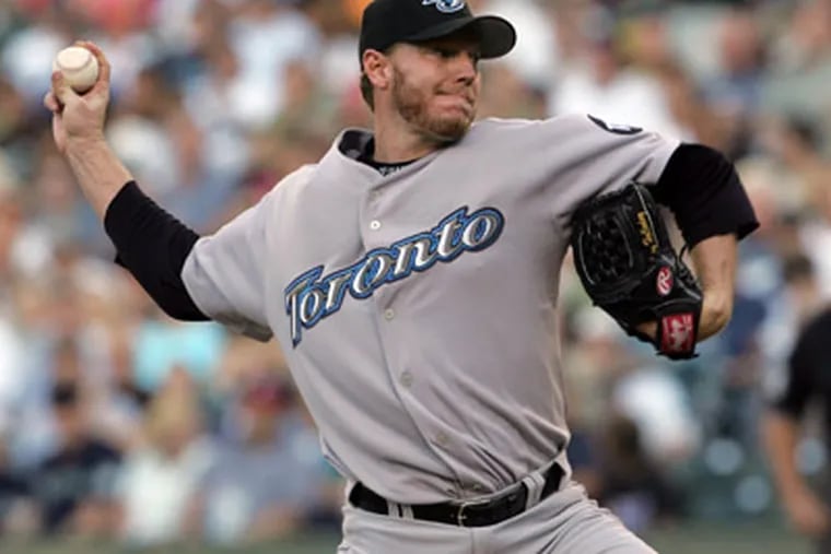 A reported blockbuster three-way trade would bring Roy Halladay to Philadelphia and send Cliff Lee to Seattle. (Kevin P. Casey/AP file photo)