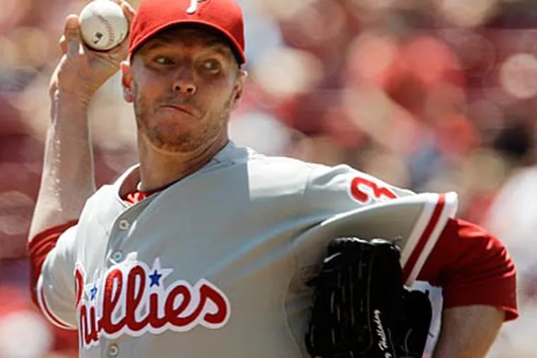 Roy Halladay pitched a complete game, but picked up the loss in yesterday's game against the Reds. (AP Photo / Al Behrman)