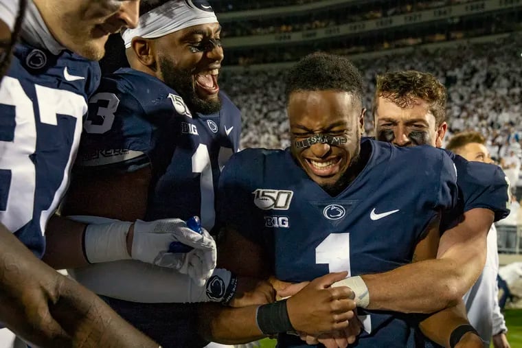Penn State quarterback Sean Clifford grabs Penn State wide receiver KJ Hamler in celebration after their team defeated Michigan, 28-21, at Penn State's Beaver Stadium on Saturday, Oct. 19, 2019.