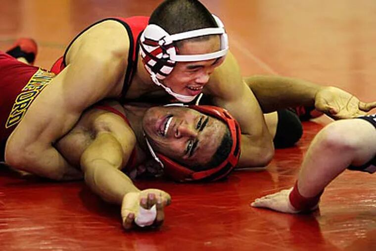 Northeast's Alan Huang pins Frankford's Calvin Oquendo in a 135-pound match. (Laurence Kesterson/Staff Photographer)