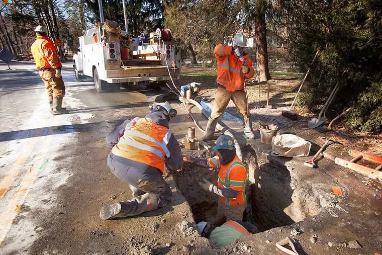 An Aqua Pennsylvania repair crew works on a ruptured water main in Merion Station.