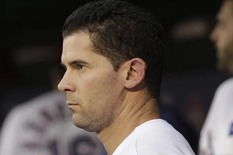 Texas Rangers' Michael Young (10) stands in the dugout during a baseball game against the Oakland Athletics Monday, Sept. 24, 2012, in Arlington, Texas. The Rangers won 5-4. (AP Photo/Tony Gutierrez)
