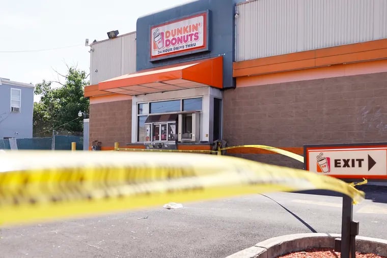 The Dunkin' Donuts, 532 W Lehigh Ave. in Phila. is closed and is surrounded by police tape after the manager, Christine Lugo, was shot in the head and killed in an apparent robbery there earlier in the day on June 5, 2021. A memorial to Christine is building as the friends and coworkers gather outside of the store.