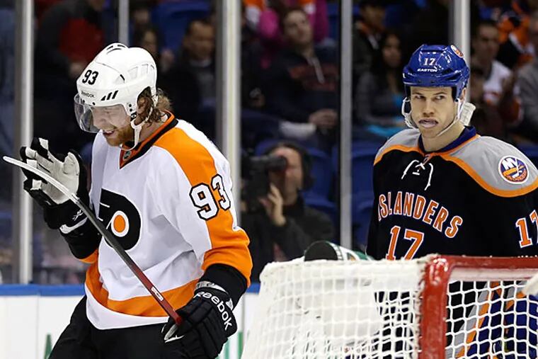 The Flyers' Jakub Voracek reacts after missing a goal during a power play while the Islanders' Matt Martin looks on during the first period. (Seth Wenig/AP)