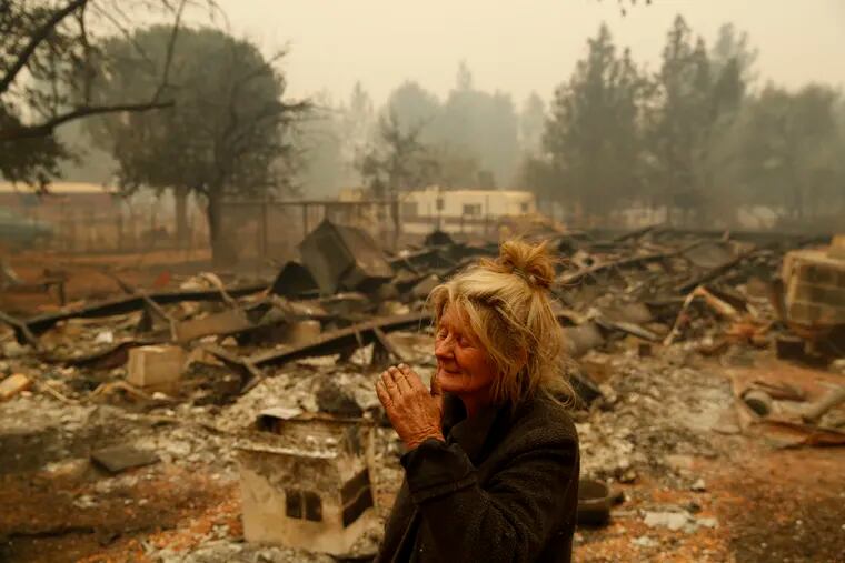 Cathy Fallon reacts as she stands near the charred remains of her home in Paradise, Calif., on Nov. 9. "I'll be darned if I'm gonna let those horses burn in the fire" said Fallon, who stayed on her property to protect her 14 horses, "It has to be true love."