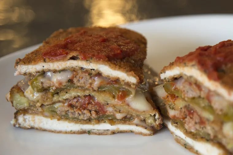 The &quot;Cutlet Stack,&quot; a stack of chicken cutlets, eggplant cutlet and sausage-stuffed long hots cooked Parmesan style at Cotoletta, in Bala Cynwyd.