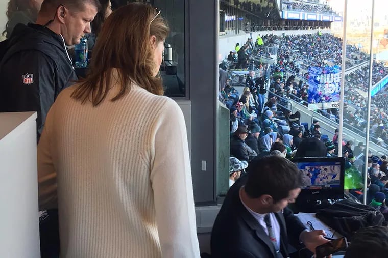 Inquirer reporter Jeff McLane being ejected from the press box at Lincoln Financial Field on Sunday by Anne Gordon, the Eagles' senior vice president of marketing, media and communications, and a security guard.