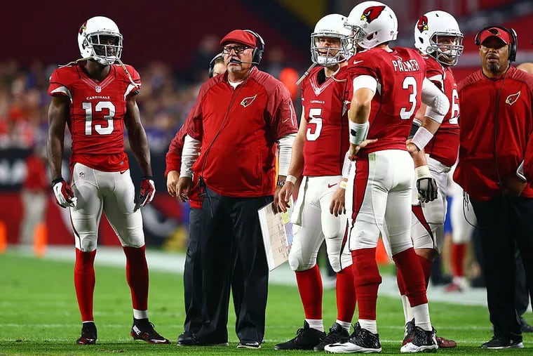 Arizona Cardinals head coach Bruce Arians (center) on the field with his players against the Minnesota Vikings at University of Phoenix Stadium. The Cardinals defeated the Vikings 23-20.
