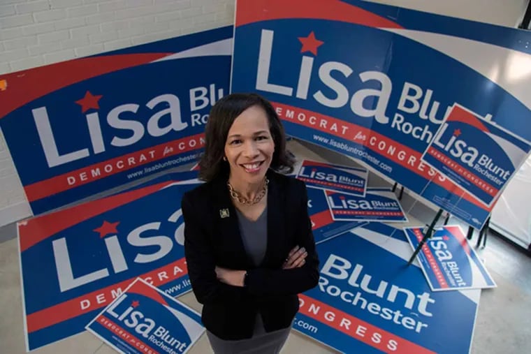 Lisa Blunt Rochester, a Democratic candidate for Congress seeking to make history in Delaware, stands amid campaign posters in her Wilmington office.