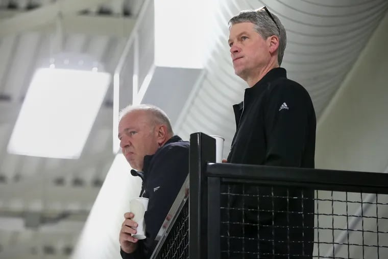 Flyers GM Chuck Fletcher (right) will try to add some scoring depth before the Feb. 24 trade deadline, but limited cap space is working against him.