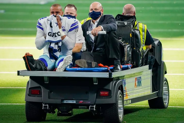 Dallas Cowboys quarterback Dak Prescott leaves the field on a cart after being injured on a tackle by New York Giants cornerback Logan Ryan on Sunday.  (Smiley N. Pool / The Dallas Morning News)