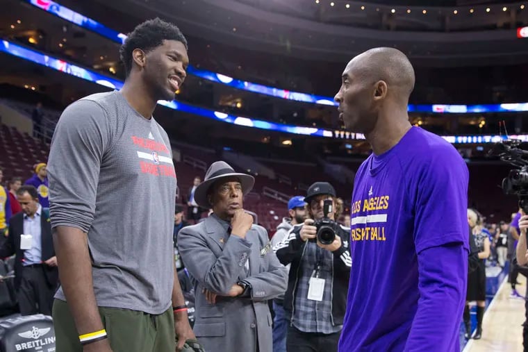 Joel Embiid talks to Kobe Bryant prior to a game on Dec. 1, 2015 at the Wells Fargo Center.