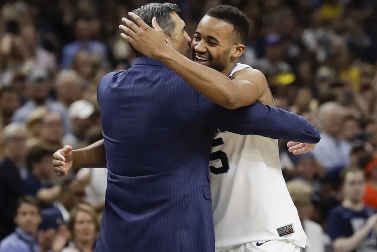 Villanova guard Phil Booth hugs coach Jay Wright during the Wildcats’ NCAA championship win on Monday. Booth will be counted upon to provide leadership for the Wildcats next season.
