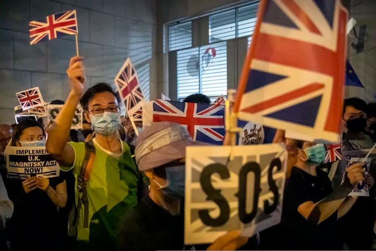 Demonstrators wave British flags during a rally outside the British Consulate in Hong Kong. From Tokyo to Brussels, political leaders have swiftly decried Beijing's move to impose a tough national security law on Hong Kong that cracks down on subversive activity and protest in the semi-autonomous territory. But the rhetoric from democratic nations has more bark than bite.
