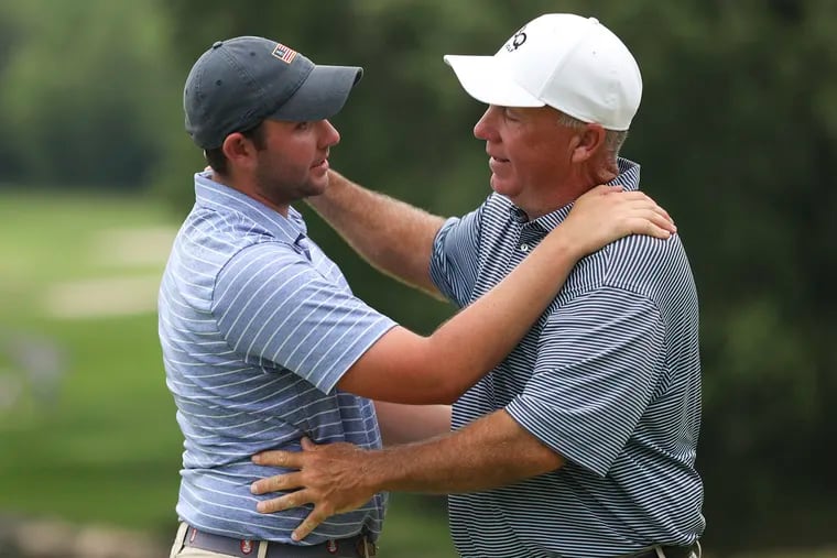 Conor McGrath (left) is congratulated by Temple golf coach Brian Quinn after defeating Jack Irons for the 121st BMW Philadelphia Amateur Golf Championship trophy at Cedarbrook Country Club.