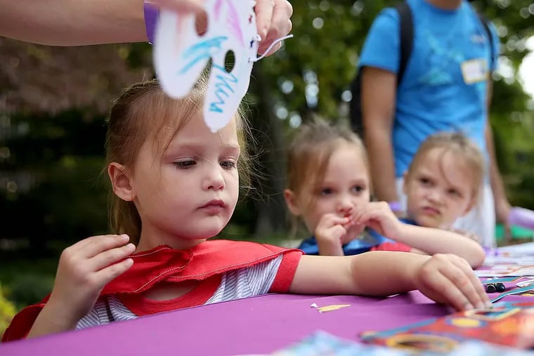 Kate Kell, left, and her two sisters, Sarah, center, and Emily, right, who are triplets, work on making masks during the 2017 ICN Reunion at Pennsylvania hospital in Philadelphia, PA on October 7, 2017.