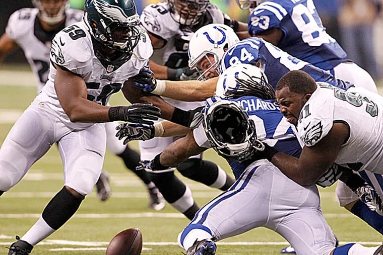 Eagles linebacker DeMeco Ryans and defensive lineman Fletcher Cox force a turnover. (Ron Cortes/Staff Photographer)