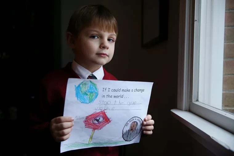 John Koger, 6, a first-grader at St. Mary Interparochial School, sits for a portrait with a drawing expressing his desire to end gun violence, shown at his Philadelphia home on Friday, Jan. 12, 2018.