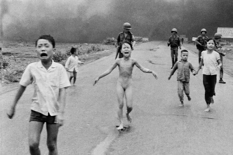 In Nick Ut's Pullitzer Prize-winning June 8, 1972 file photo, South Vietnamese forces follow after terrified children, including 9-year-old Kim Phuc, center, as they run down Route 1 near Trang Bang after an aerial napalm attack on suspected Viet Cong hiding places.