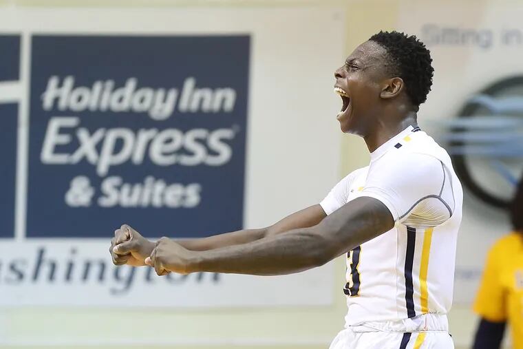 La Salle's Saul Phiri celebrates after drawing an offensive foul during the Explorers' win over UMass at Tom Gola Arena. Phiri was the Explorers' leading scorer with 14 points.
