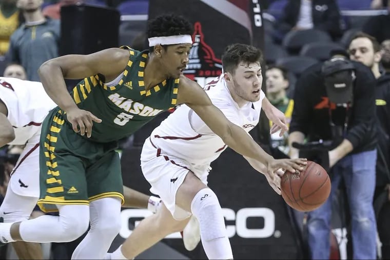 St. Joseph’s Taylor Funk and George Mason’s Jaire Grayer try for the loos ball during the 2nd half of the A-10 tournament, quarterfinals, at the Capital One Arena, in Washington, DC, Friday, March 9, 2018. St. Joes beat Mason 68-49 to advance to the Semifinals.