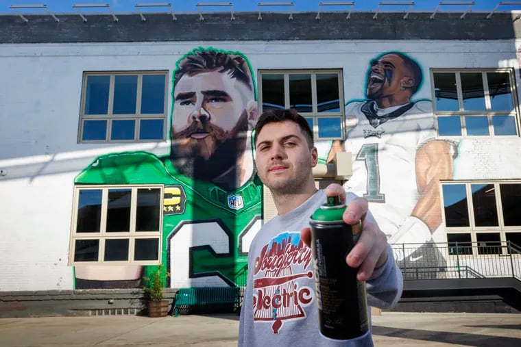 Joey Dougherty, of Dougherty Electric Inc., painted murals of Eagles center Jason Kelce and quarterback Jalen Hurts on the wall of his family business at 45 E. Porter Street in South Philadelphia. He plans to add more athletes to the wall.