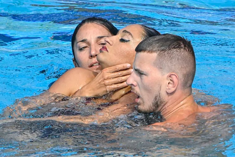 Anita Alvarez of the United States (center) is taken from the pool after collapsing during the solo free final of the artistic swimming at the 19th FINA World Championships in Budapest, Hungary, on Wednesday.