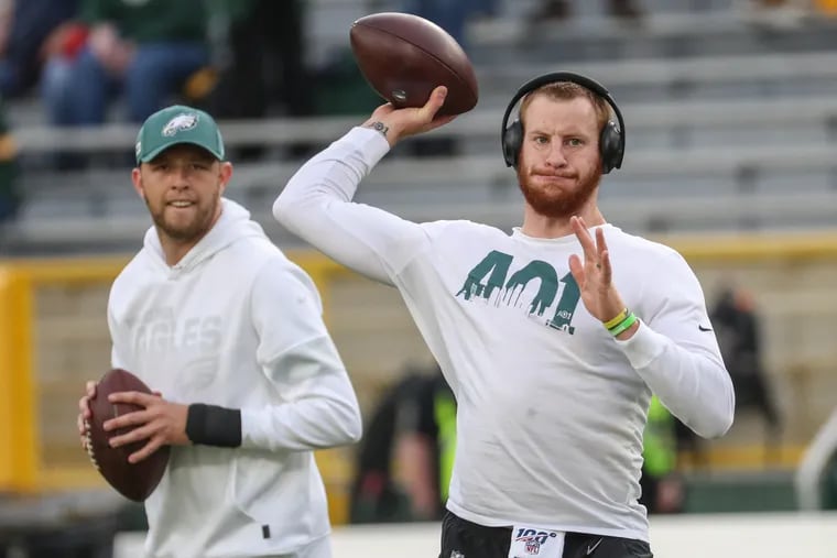 Both Carson Wentz (right) and Nate Sudfeld are returning to the Eagles' quarterback room from last season.