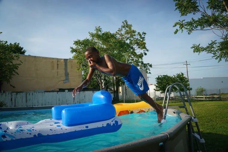 Quadir Staton, 10 years old, jumps into a pool, in North Philadelphia on Tuesday. The heat has only just begun.