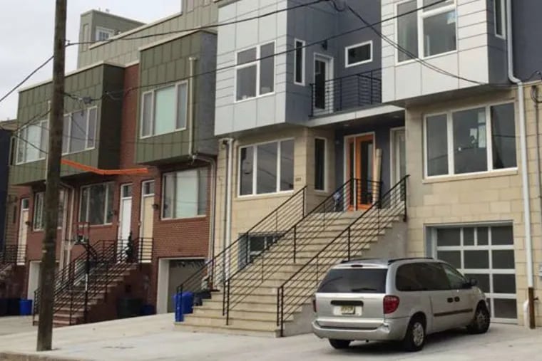 Roxborough's new large, townhouses, built with empty-nesters in mind, feature garages and parking pads rather than traditional front gardens.