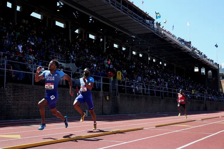 Team USA Blue's Champ Page, left, and Team USA Red's Manteo Mitchell run in the USA vs. the World men's sprint medley during the 125th annual Penn Relays at Franklin Field in Philadelphia on Saturday, April 27, 2019. Kenya won the event, with USA Red finished second and USA Blue finishing fourth.