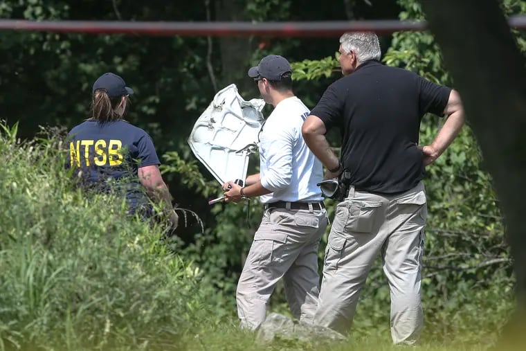 NTSB's Adam Gerhardt, center, investigates debris form a small plane crash in Upper Moreland Township, The crash killed all three people on board. The crash occurred about 6:20 a.m. in the area of Morris Road and Minnie roads
Thursday, August 8, 2019