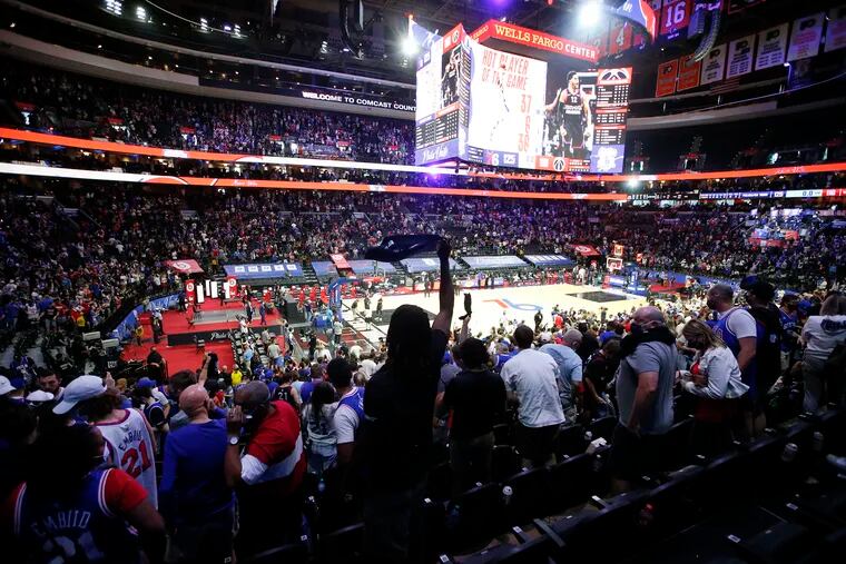 Sixers fans celebrate their team's 125-118 win last week in the first win of their series vs. the Washington Wizards.
