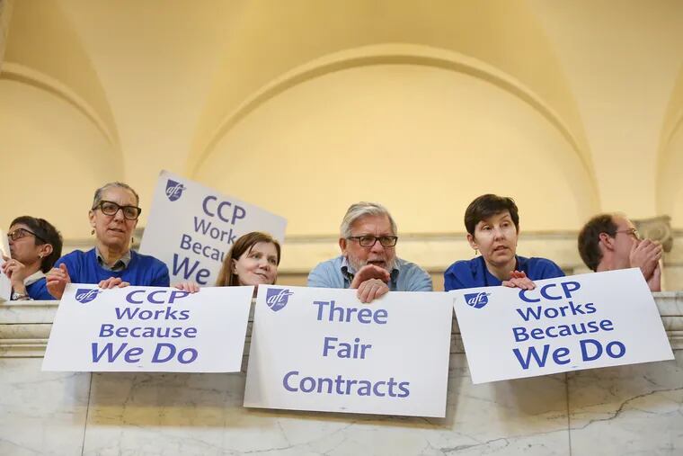 Attendees hold signs at a rally supporting unionized faculty and staff at the Community College of Philadelphia during marathon contract negotiations that ended this week.
