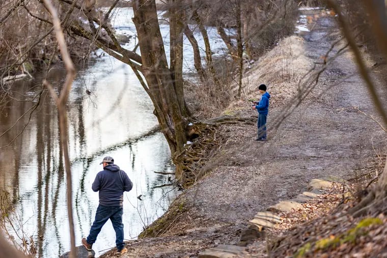 Sebastian Resendiz, 13, and his dad, Roberta Resendiz, of Collegeville, Pa., fish along Valley Creek Trail at the Valley Forge National Historical Park.