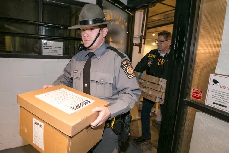 State police carry out boxes of evidence from the offices of Field Works in East Falls on Nov. 3, 2016.