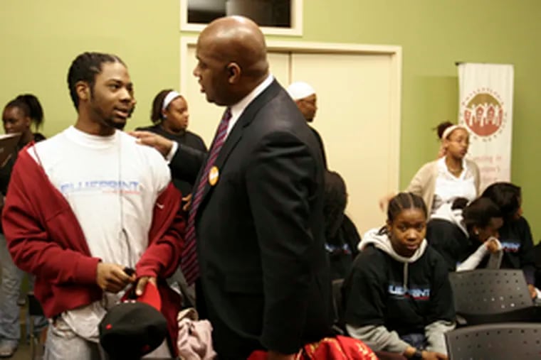 State Rep. Dwight Evans (right) talks with Lionel Parks, 17, after pledging $820,000 in state funding to the Philadelphia Youth Network. The money will help make up a shortage in funds to hire youths for summer jobs. He challenged other agencies to raise another $480,000.