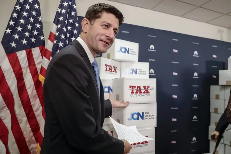 House Speaker Paul Ryan (R., Wis.) points to boxes of petitions supporting the Republican tax reform bill that was voted on earlier this month.