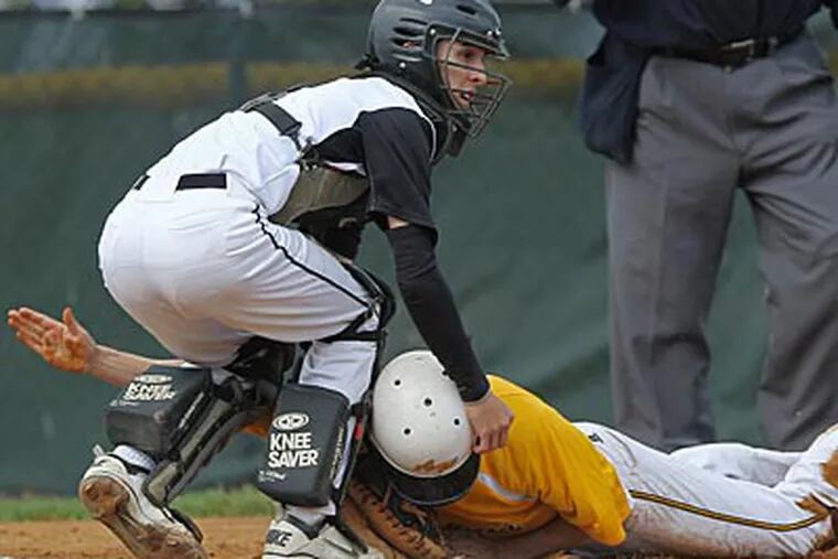 Neuman-Goretti's Nicky Nardini tags out Archbishop Wood's Sean Sheridan in the first inning. (Michael Bryant/Staff Photographer)