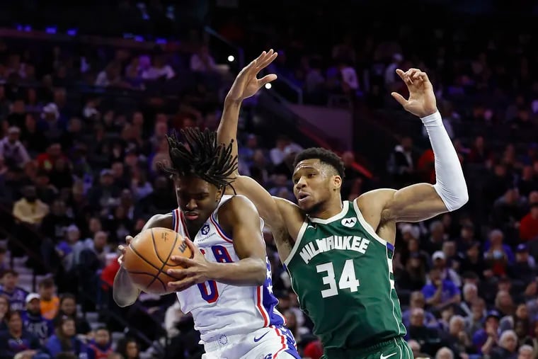 Sixers guard Tyrese Maxey grabs a rebound in front of Milwaukee's Giannis Antetokounmpo during third quarter.