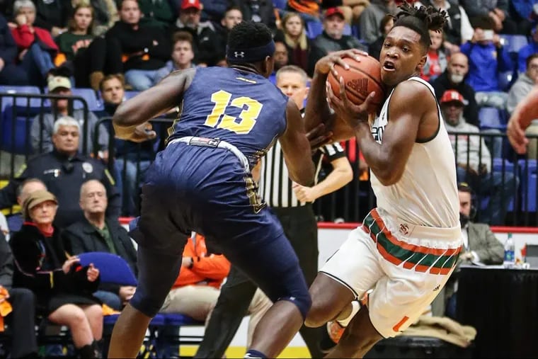 Miami’s Lonnie Walker IV, a Reading High School graduate, drives on La Salle’s Saul Phiri during the first half at the Santander Arena in Reading.