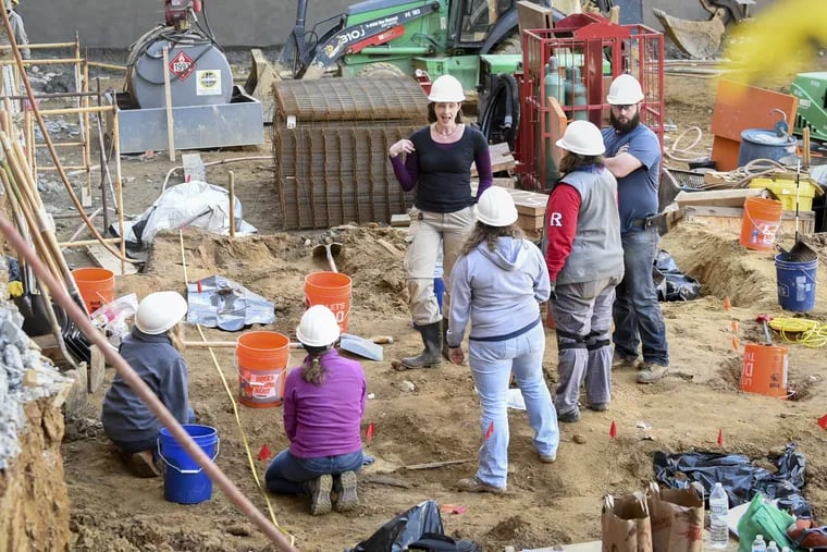 Volunteer archaeologists work to exhume bodies buried at the Former First Baptist burial ground on Wednesday afternoon, March 8, 2017 as a construction company clears the space for construction of an apartment building.