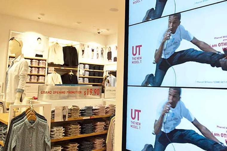 Some of the 46 video monitors in the Japanese-based fashion chain Uniqlo opening in the King of Prussia mall.  (Ron Tarver/Staff
Photographer)