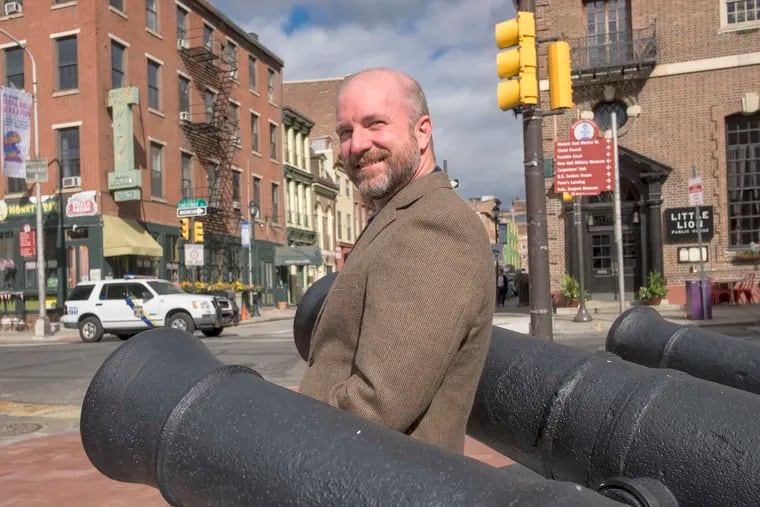 Philip Mead is surrounded by cannons from the Revolutionary War era in front of the museum at Third and Chestnut Streets.
