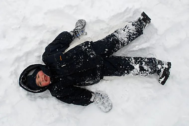 Alex Grizzo made a snow angel after a tumble on the sledding hill in Laurel Acres Park in Mount Laurel, N.J., in March. (TOM GRALISH / Staff Photographer)