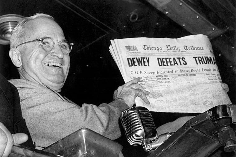 In this Nov. 4, 1948, file photo, President Harry S. Truman at St. Louis' Union Station holds up an Election Day edition of the Chicago Daily Tribune, which — based on early results — mistakenly announced "Dewey Defeats Truman."