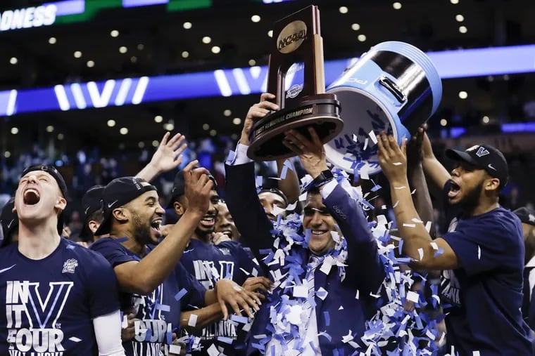 Villanova Head Coach Jay Wright gets the confetti shower holding the East Regional Championship trophy after beating Texas Tech on Sunday at the TD Garden in Boston. Villanova advances to the Final Four.