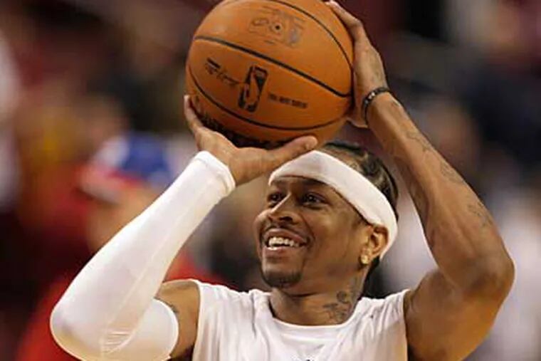 Sixers' Allen Iverson shoots the basketball with a smile during warm-ups. (Yong Kim / Staff Photographer)